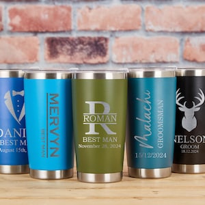 May include: Five stainless steel insulated tumblers in various colors, each with personalized text and designs. The tumblers feature names, dates, and titles like "Best Man" and "Groom". The designs include a tuxedo, a deer head, and initials.