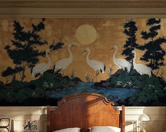 May include: A bedroom with a large mural featuring white cranes flying over a blue lake and green trees. The mural is on a gold background. The bedroom has a wooden bed with white linens, a floral patterned armchair, and a wooden nightstand with a lamp.