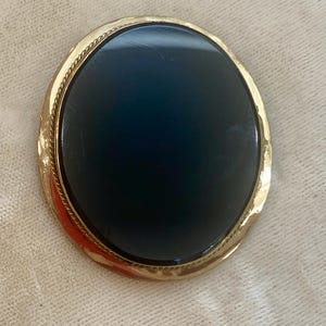 A Victorian Brooch in Black Glass and Rich Gold Tone