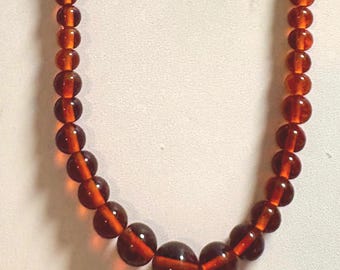 A Vintage Necklace With Smooth Round Glass Beads in a Shade of Amber or Cognac or Rootbeer...