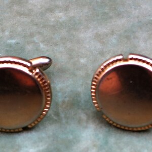 A Pair of Vintage Gold Tone Cufflinks by SWANK