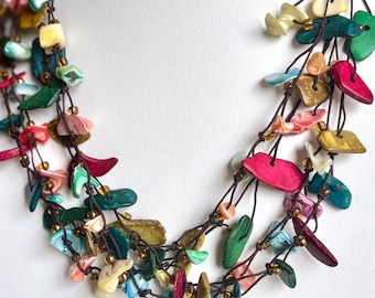 A Necklace of Colorful Pieces of Coconut Strung on Frayed Black Cord