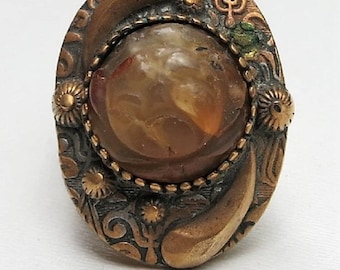 A Ring with a Carved Opalescent Agate in an Art Nouveau Setting