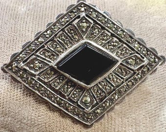 A Vintage Sterling Silver and Marcasite and Onyx Brooch