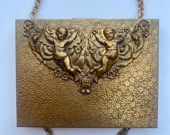 A Unique Vintage Case with Hearts and Angels on a Long Chain