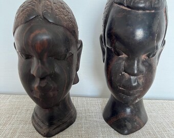 A pair of hand carved wooden African busts