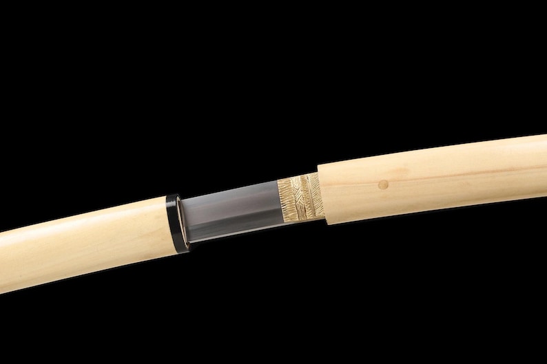 May include: A Japanese katana sword with a light-colored wooden scabbard. The blade is partially visible, with a dark gray color. The hilt features a black ring. The scabbard has a gold-colored decorative element near the blade.