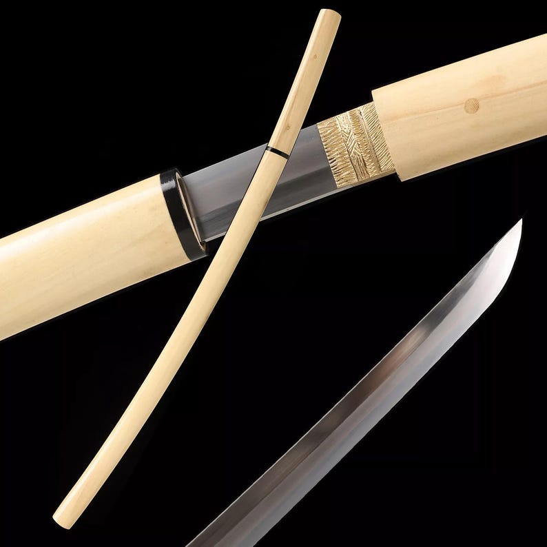 May include: A Japanese katana sword with a wooden scabbard and handle. The blade is silver and the scabbard is light-colored wood with gold accents. The handle is a light-colored wood with a black band.