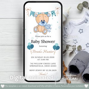 Op de afbeelding: Een digitale uitnodiging voor een babyshower op een smartphone, met een teddybeer illustratie en blauwe accenten. De uitnodiging bevat evenementdetails en de tekst "Digital animated Invitation". Babykleding en slofjes op de achtergrond.