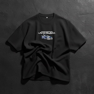 May include: Black short-sleeved t-shirt featuring the text "Need for Speed Most Wanted" above a graphic of a blue and white sports car. The shirt is made of a soft material and has a crew neck.
