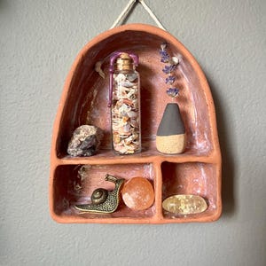 handmade ceramic wall curio cabinet // mini cabinet all shelf // terra cotta colored altar // southwestern vibes //