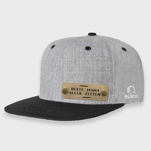 May include: Gray and black baseball cap with a gold metal plate that reads "Beste aller Zeiten Mama". The cap has a black underside and a small logo on the side that reads "Rubde".