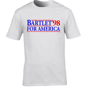 May include: White t-shirt with blue and red text that reads "Bartlet '98 For America"