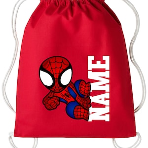 May include: Red drawstring bag with a cartoon Spider-Man design. The character is in red and blue with white eyes. The word "NAME" is printed vertically in white block letters on the right side. White drawstrings complete the design.