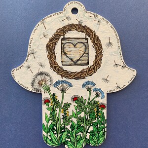 Wild flower garden with wooden heart wreath Hamsa hand.
