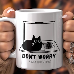 May include: White ceramic mug with a black cat sitting on a laptop. The mug has the text "Don't Worry I'm From Tech Support" printed on it.
