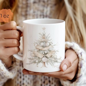 May include: White ceramic mug with a watercolor illustration of a Christmas tree with white and beige ornaments. The mug is 11 oz.