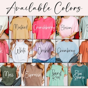 May include: A display of t-shirts in various colors, including ivory, mustard, crunchberry, blossom, and bay. Other colors are brick, white, orchid, chambray, yam, moss, espresso, island reef, and blue spruce. The text "Available Colors" is at the top.