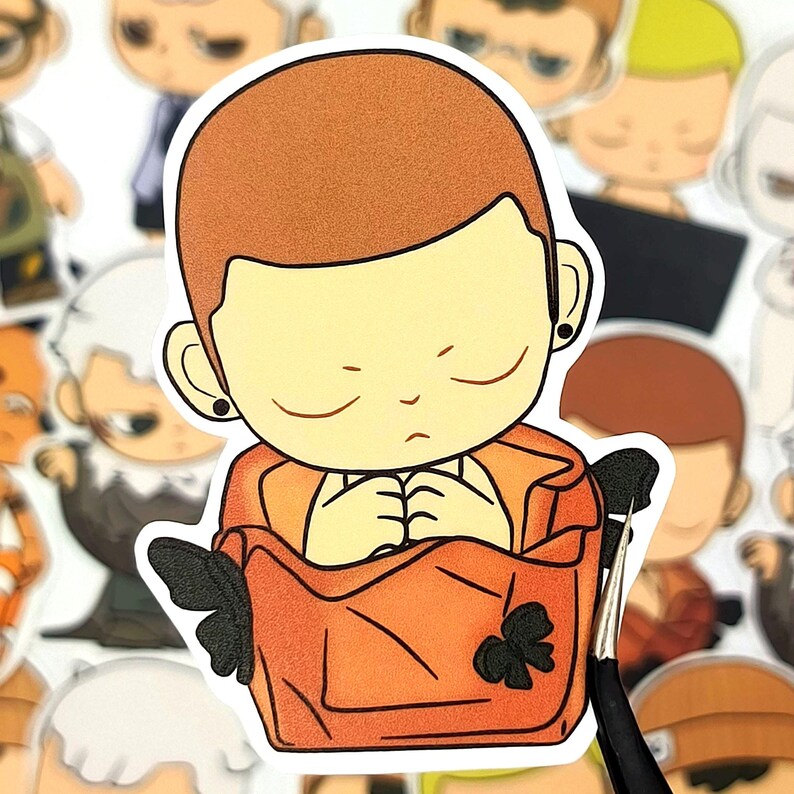 May include: A sticker featuring a cartoon character with closed eyes, wearing an orange outfit. The character is in a seated position with hands clasped. The sticker has a white border and is surrounded by other similar stickers.