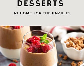 May include: Two glass jars filled with a layered dessert. The bottom layer is white, the middle layer is brown, and the top layer is topped with fresh raspberries and a sprig of mint. The jars are sitting on a dark grey surface with scattered raspberries and granola.