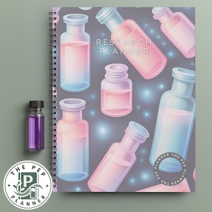 May include: A spiral-bound Research Planner notebook featuring a pattern of glass bottles filled with pink and blue liquid on a dark gray background with glowing light spots. A small clear bottle with a black cap containing purple liquid sits nearby.