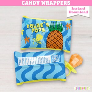Pode incluir: Embalagens de doces com um design azul e amarelo. As embalagens apresentam o texto "Kolbe's Pops" e um gráfico de abacaxi. As embalagens também incluem informações nutricionais e um código QR.