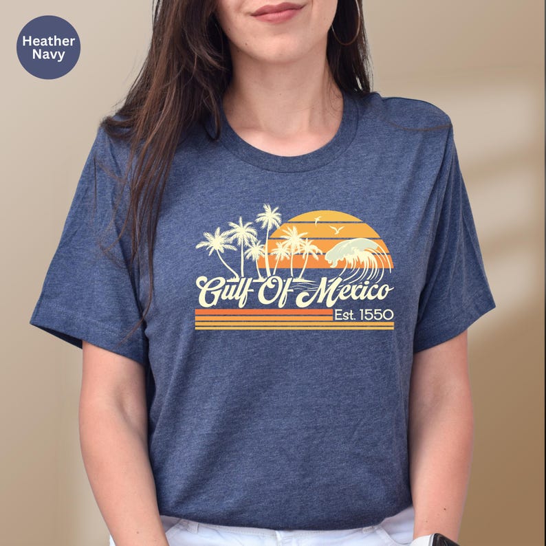 a woman wearing a blue shirt with palm trees on it