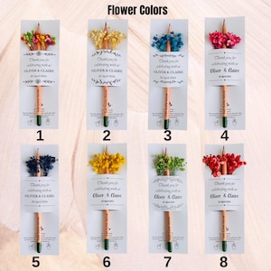 May include: A collection of eight pencils with attached floral arrangements in various colors. Each pencil is packaged with a card that reads "Thank you for celebrating with us Oliver & Claire 20 April 2024" and "Let Love Grow."