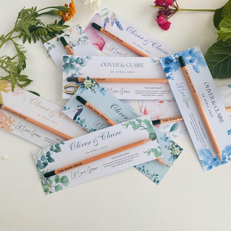 May include: A set of wedding favor pencils with a floral design and the text "Let Love Grow" and "Oliver & Claire" with the date "20 April 2024".