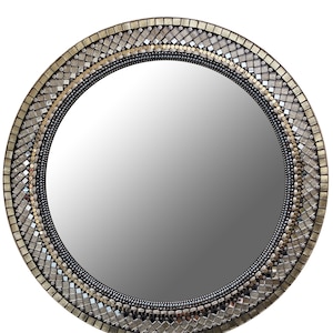 May include: A round wall mirror featuring a decorative frame composed of concentric rings of small, square metallic tiles in shades of gold, bronze, and silver, with a central circular reflective glass surface and a dark, textured inner border.