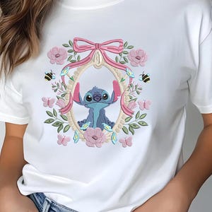 a woman wearing a white t - shirt with a stitched stitch stitch stitch stitch
