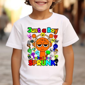 May include: White t-shirt with a colorful graphic of a cartoon character wearing headphones and the text "Just a Boy who loves SPRUNK".