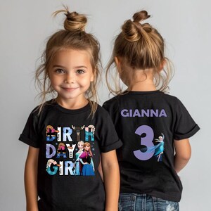 A young girl with blonde hair wearing a black t-shirt with a birthday girl design and the name Gianna printed on the back.