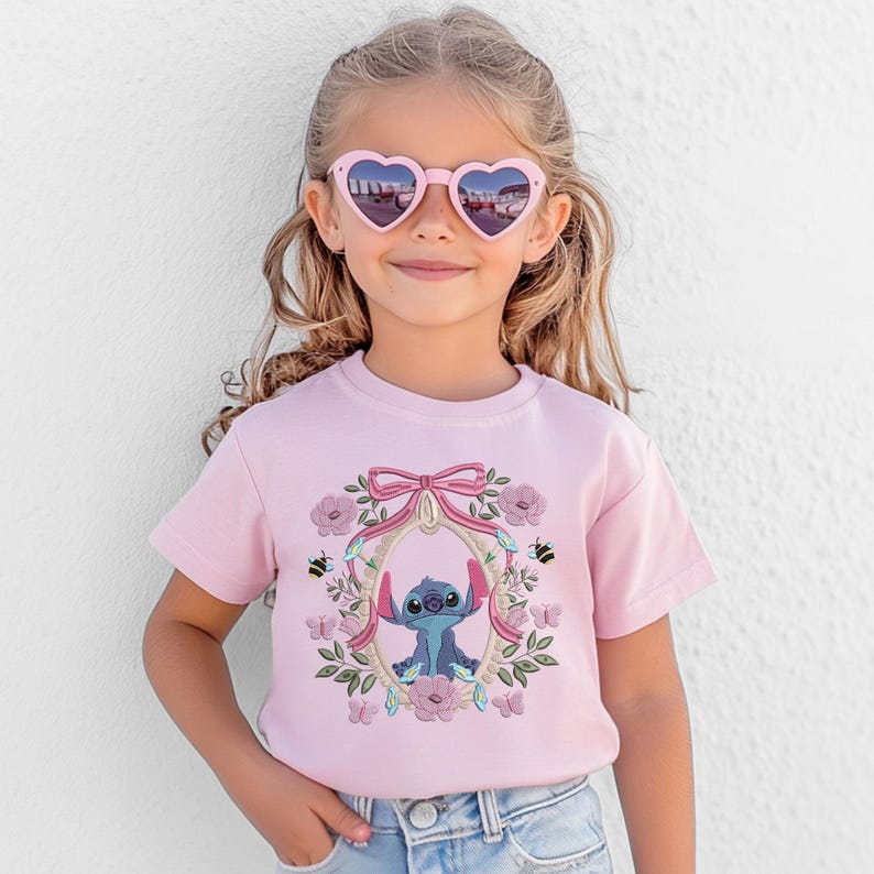 a little girl wearing a pink shirt and heart shaped sunglasses