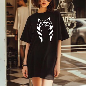 a woman standing in front of a store window