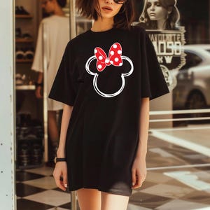 a woman standing in front of a store window