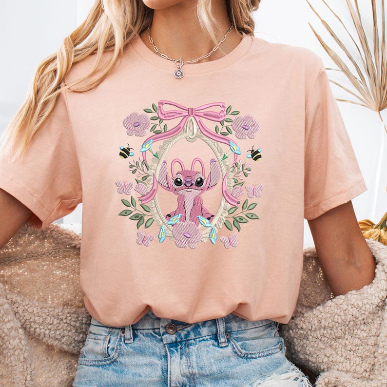 a woman wearing a pink shirt with a picture of a dog on it