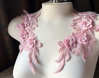May include: Two pink floral lace appliques featuring delicate flower details and leafy accents. These appliques are ideal for adding a touch of elegance to clothing, accessories, or home decor projects.