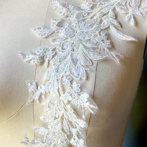 May include: A white ceramic mug with a black handle and the text "But First, Coffee" in a bold, black font. The mug is set against a neutral background, highlighting its simple design.