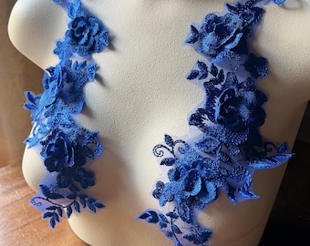 May include: Two blue floral lace appliques featuring delicate floral designs and 3D rose embellishments. The appliques are ideal for adding a touch of elegance to clothing, accessories, or home decor projects.