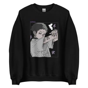 Könnte beinhalten: Schwarzer Pullover mit einem grafischen Aufdruck eines Comic-Charakters mit einer Zigarette und dem Text "REVIDELA".