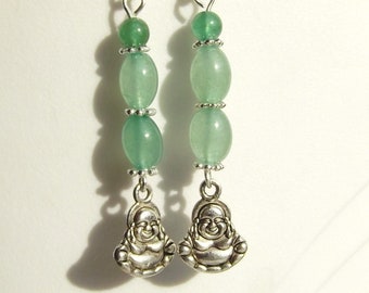 May include: Silver earrings with green jade beads and a silver charm of a smiling Buddha.