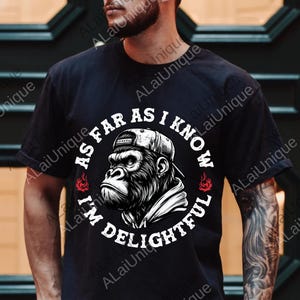 May include: Black t-shirt featuring a gorilla wearing a cap and hoodie. The graphic includes the text "AS FAR AS I KNOW I'M DELIGHTFUL" in a circular design with flames. The design is in black and white.