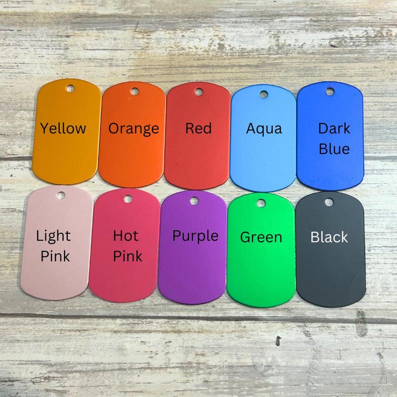 May include: Ten different colored metal dog tags with various color names printed on them. The colors are yellow, orange, red, aqua, dark blue, light pink, hot pink, purple, green, and black.
