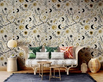 May include: A living room with a beige sofa with cushions and a cream-coloured wall with a black and gold floral wallpaper featuring moons, stars, and suns.