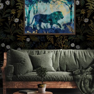 May include: A framed art print featuring a lion silhouette in a teal and blue forest scene. The artwork hangs above a green sofa with matching pillows and a wooden coffee table. The background is a dark floral wallpaper.