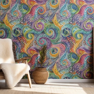 May include: A colourful abstract wall mural with a swirling pattern of dots in shades of blue, green, yellow, pink, and purple. A wooden chair with a white sheepskin throw is in front of the wall, and a wooden planter with a green plant is in the corner.