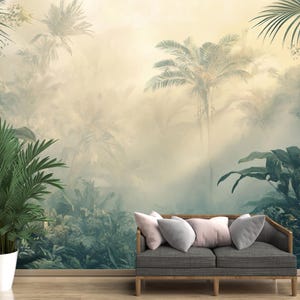May include: A digital illustration of a tropical jungle scene with lush green foliage and tall palm trees. The background is a soft, hazy yellow with a light beam shining through the trees. A gray sofa with pillows is placed in front of the jungle scene.