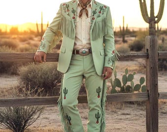 May include: A light green cowboy suit with cactus embroidery and fringe detailing. The suit includes a jacket, pants, and a matching cowboy hat. The outfit is paired with a patterned neckerchief and a belt with a large buckle. The background features a desert landscape.