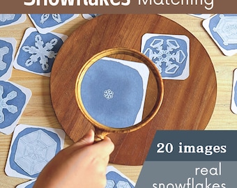May include: A set of 20 printable images of real snowflakes for a matching game. The images are on white cards with a blue background. The text "Snowflakes Matching" is at the top of the image. The text "20 images real snowflakes digital download" is at the bottom of the image.